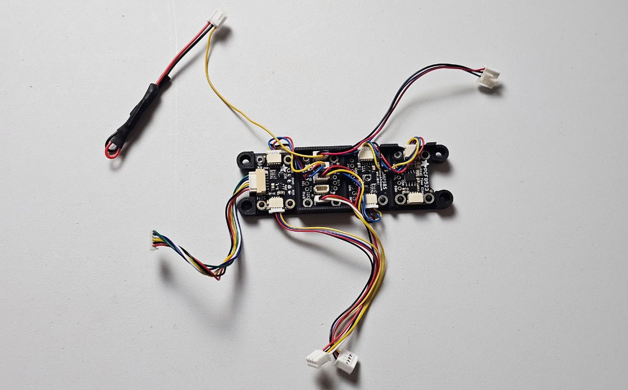 Adafruit modules in the open module bracket with both modified cable leads routed before closing