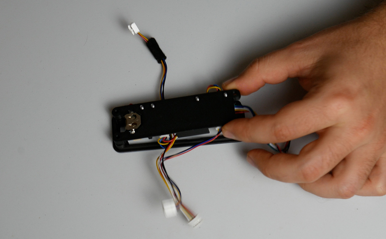 Two separated halves of the Adafruit module bracket with the Adafruit modules and cables visible inside